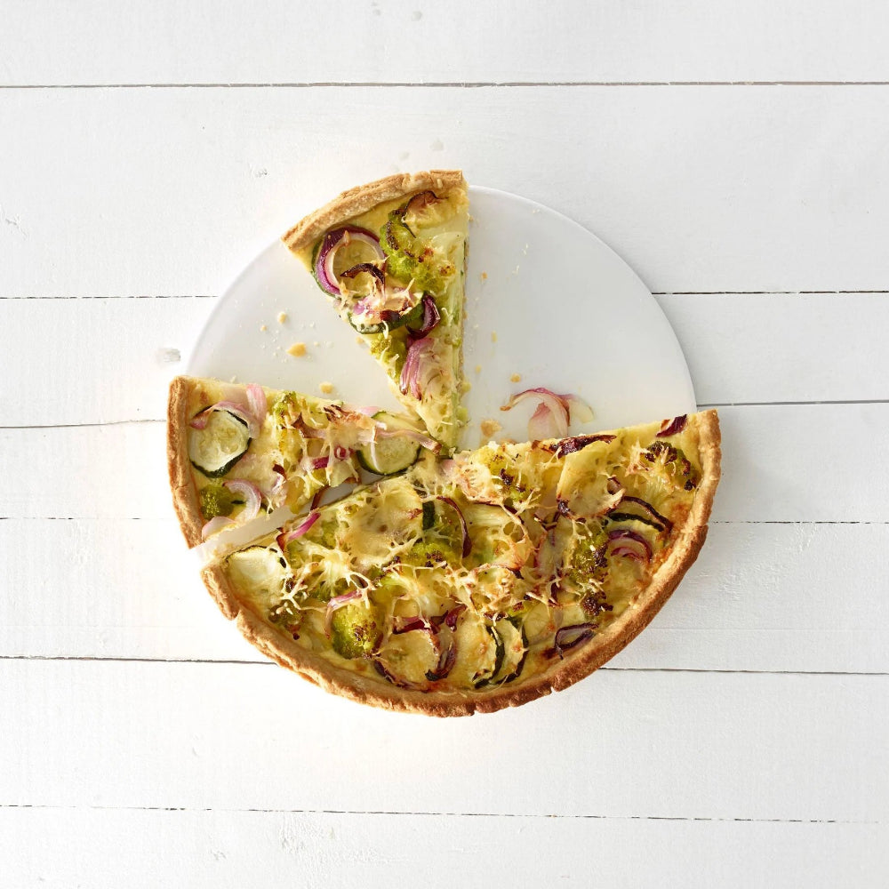 Quiche on a wooden white surface 