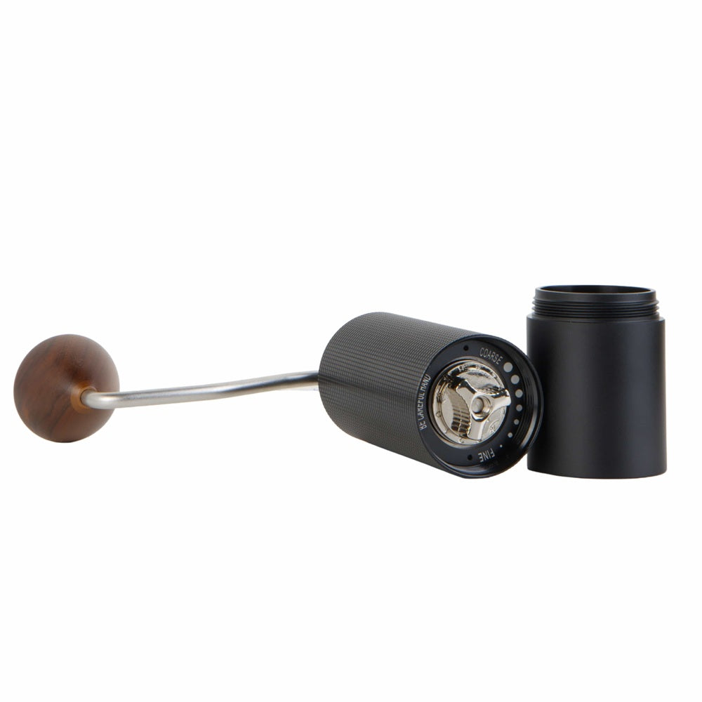Black coffee grinder with wooden handle on a white background