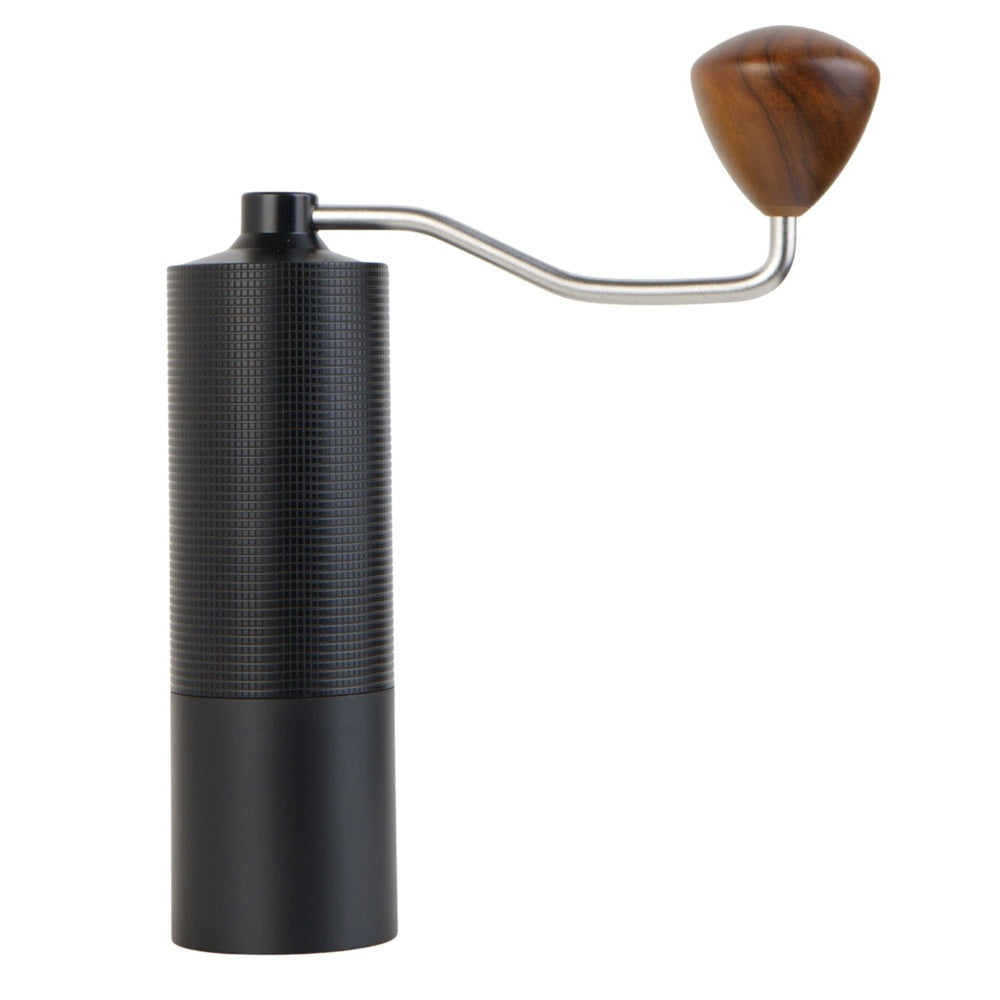 Black manual coffee grinder with a wooden handle on a white background