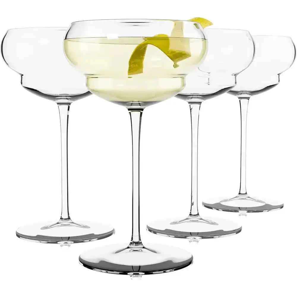 Set of four cocktail glasses with a drink and lemon twist on a white background