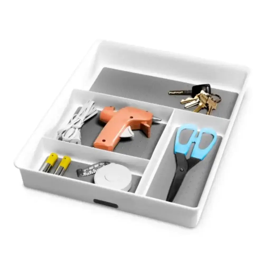 White tray with compartments holding a hot glue gun, scissors, and keys on a white background