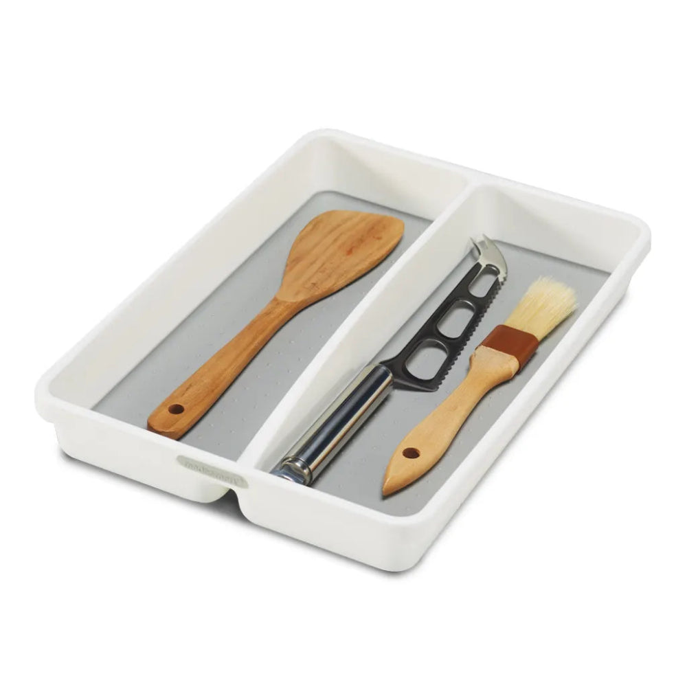 Set of kitchen utensils including a wooden spatula and basting brush in a white tray on a white background