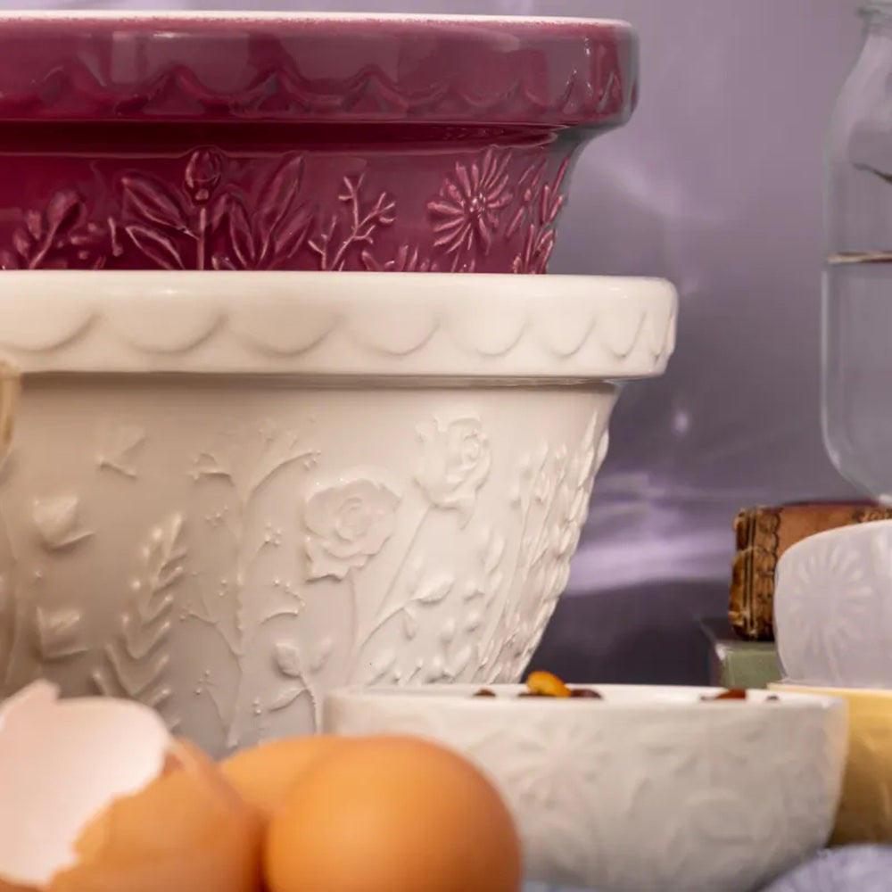 Decorative white and purple ceramic planters with a blurred background