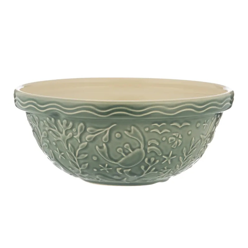 Green ceramic bowl with decorative patterns on a white background