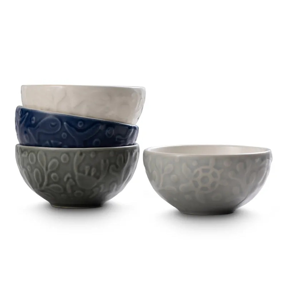 Set of four ceramic bowls in various colors on a white background