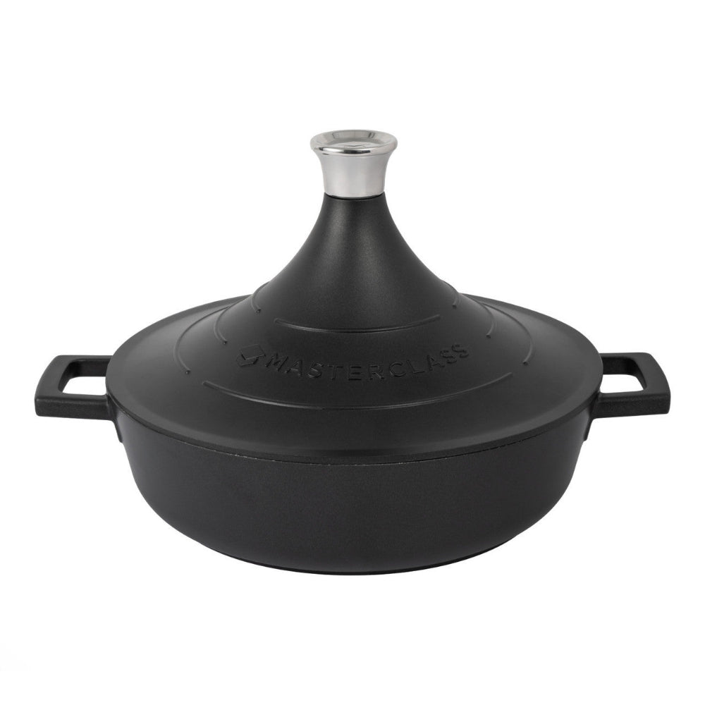 Black cast iron tagine with a silver spout on a white background