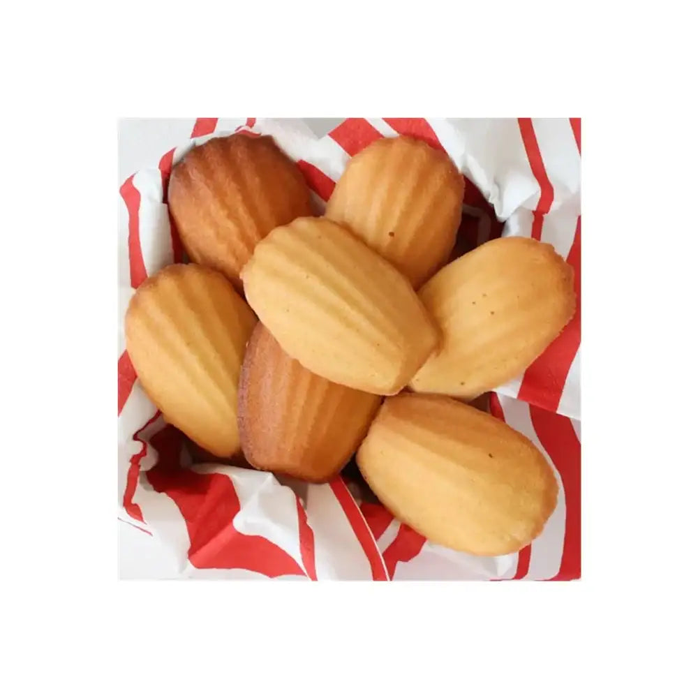 Basket of madeleines on a red and white striped paper