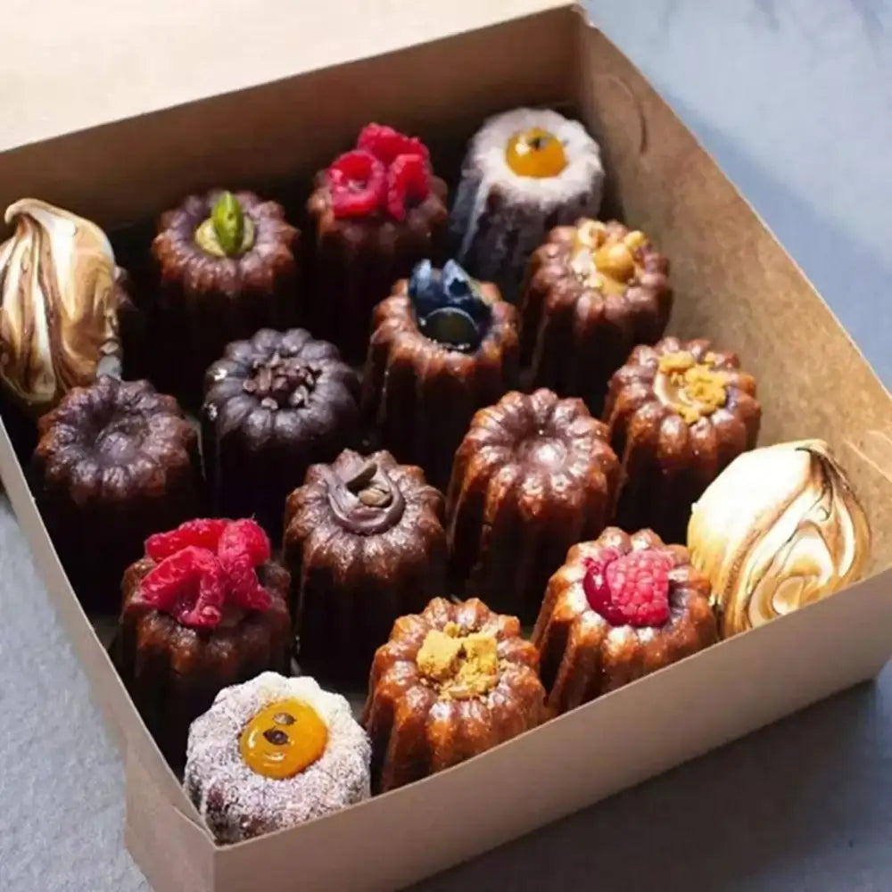 Assorted small desserts in a box on a light background