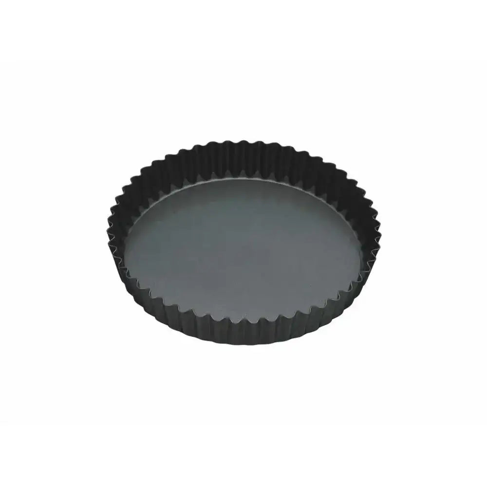 Black fluted tart pan on a white background