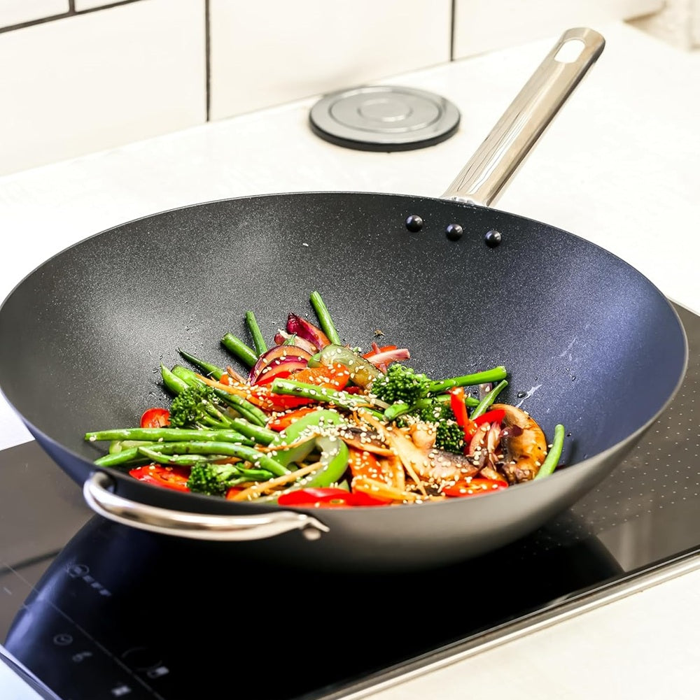 Wok with stir-fried vegetables on a stovetop