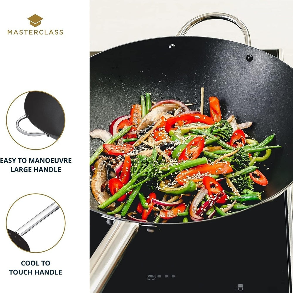 Wok with stir-fried vegetables on a stove, featuring Masterclass branding and handle features.