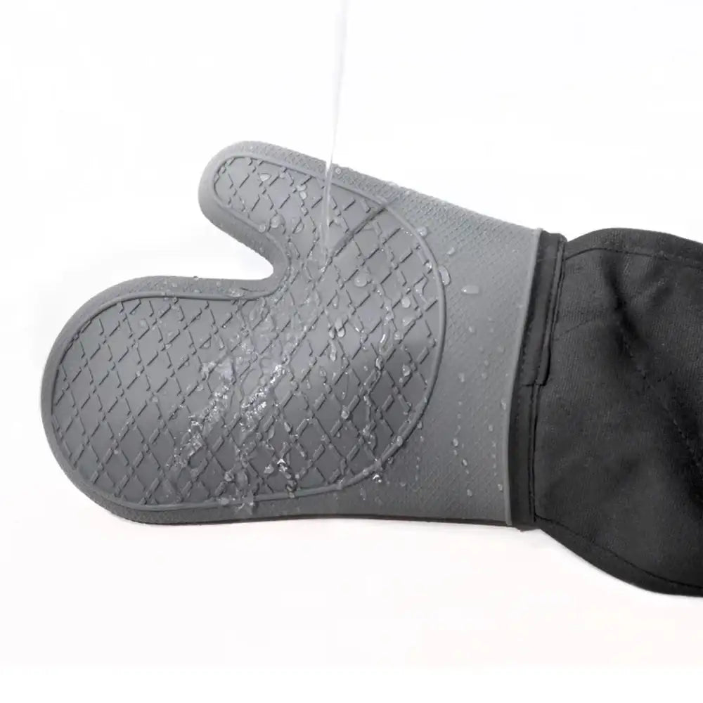 Gray silicone oven mitt with black fabric back on a white background