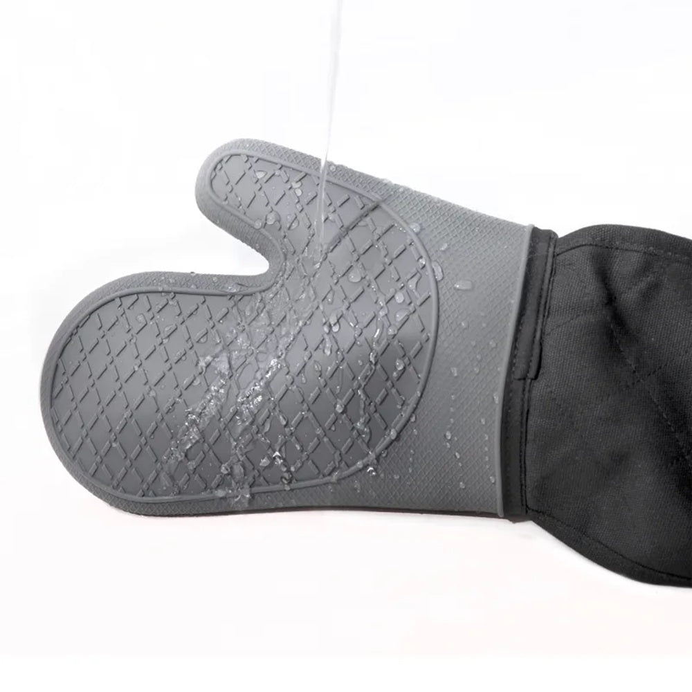Gray silicone oven mitt with black fabric back on a white background