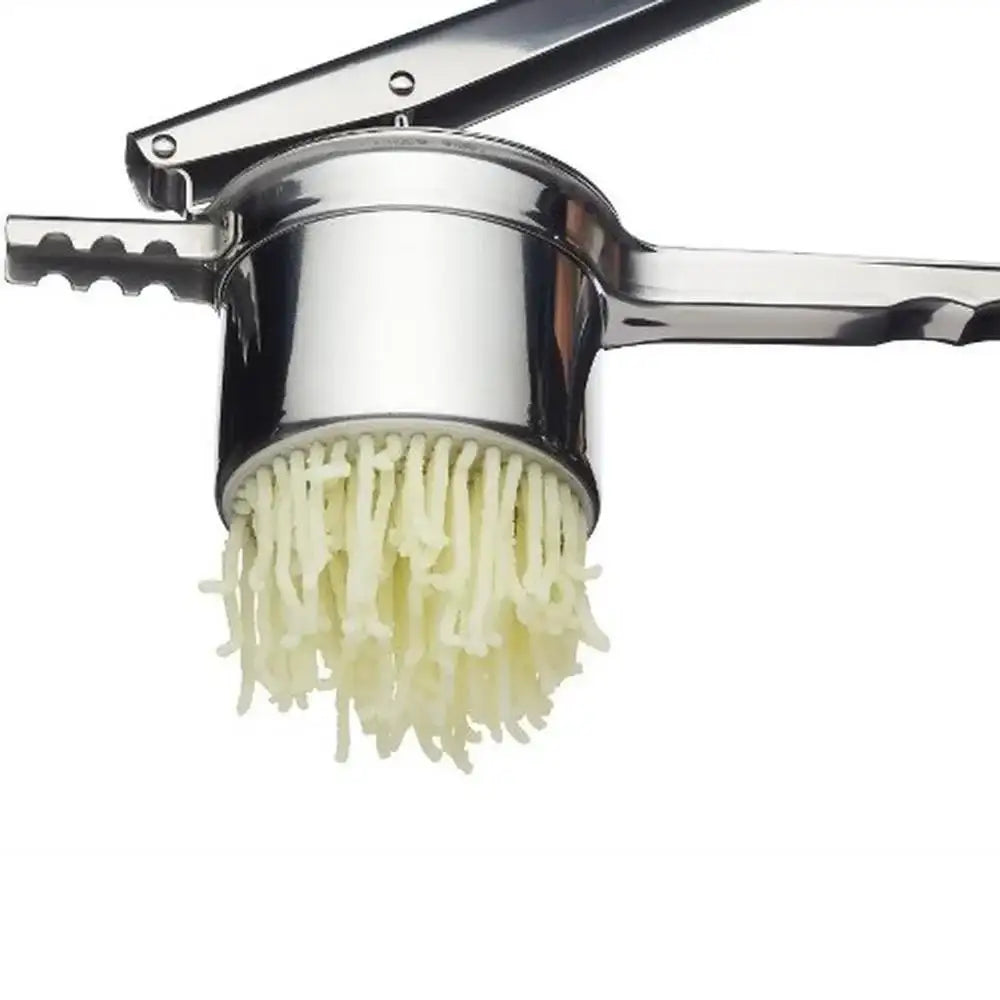 Metallic pasta maker with fresh pasta strands on a white background
