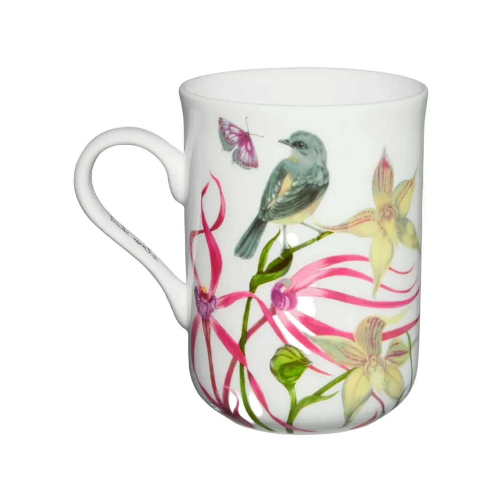 White mug with floral and bird design on a white background