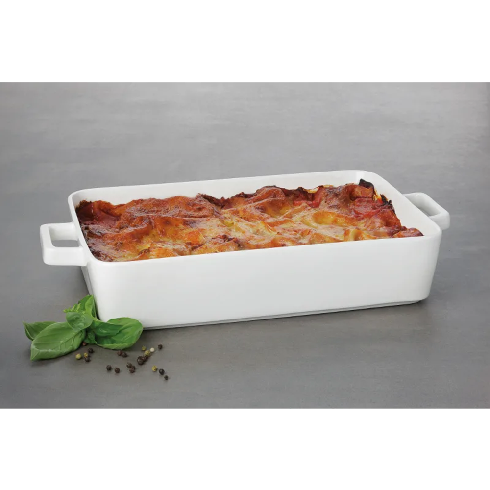 White rectangular baking dish with a lasagna on a gray background