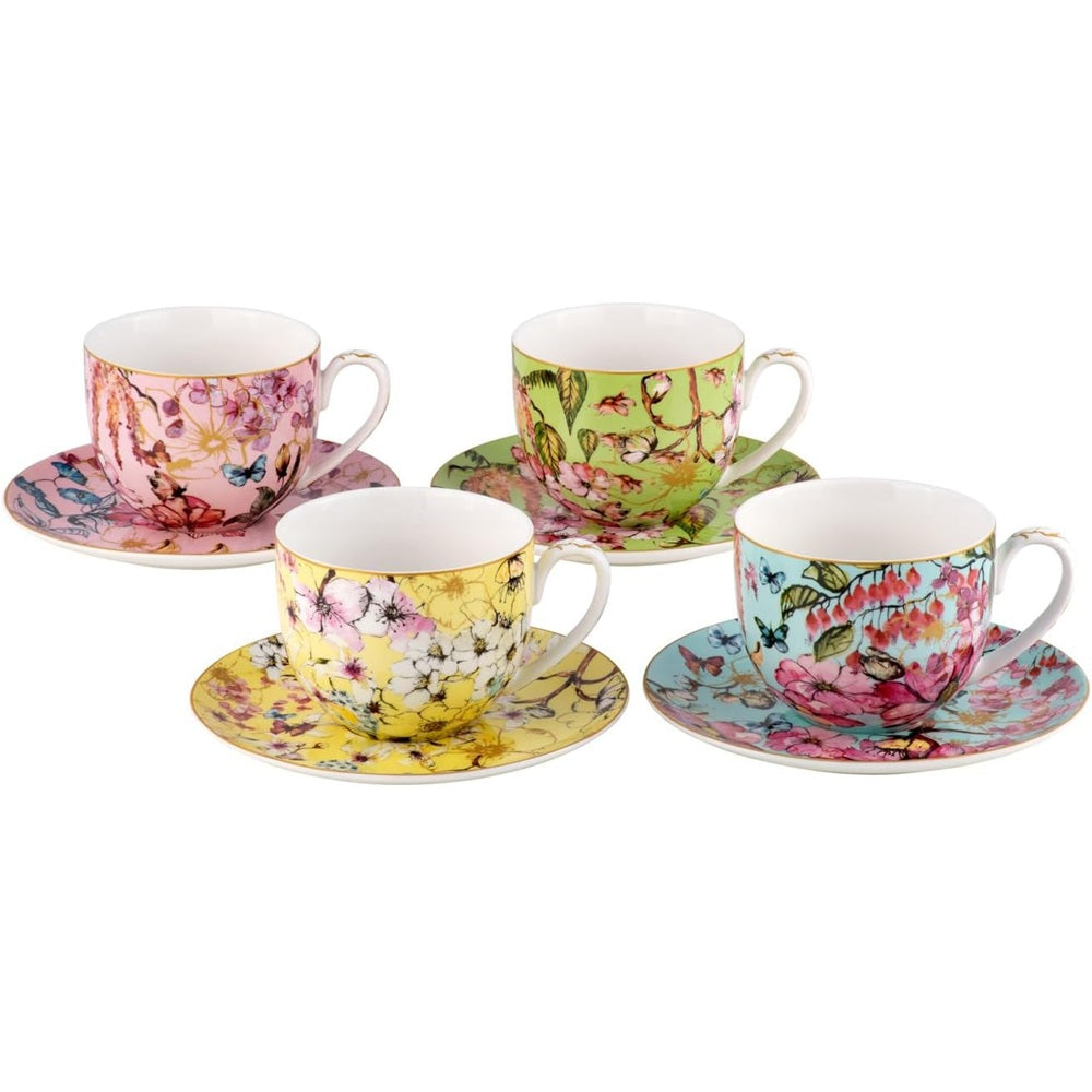 Set of four floral teacups and saucers on a white background