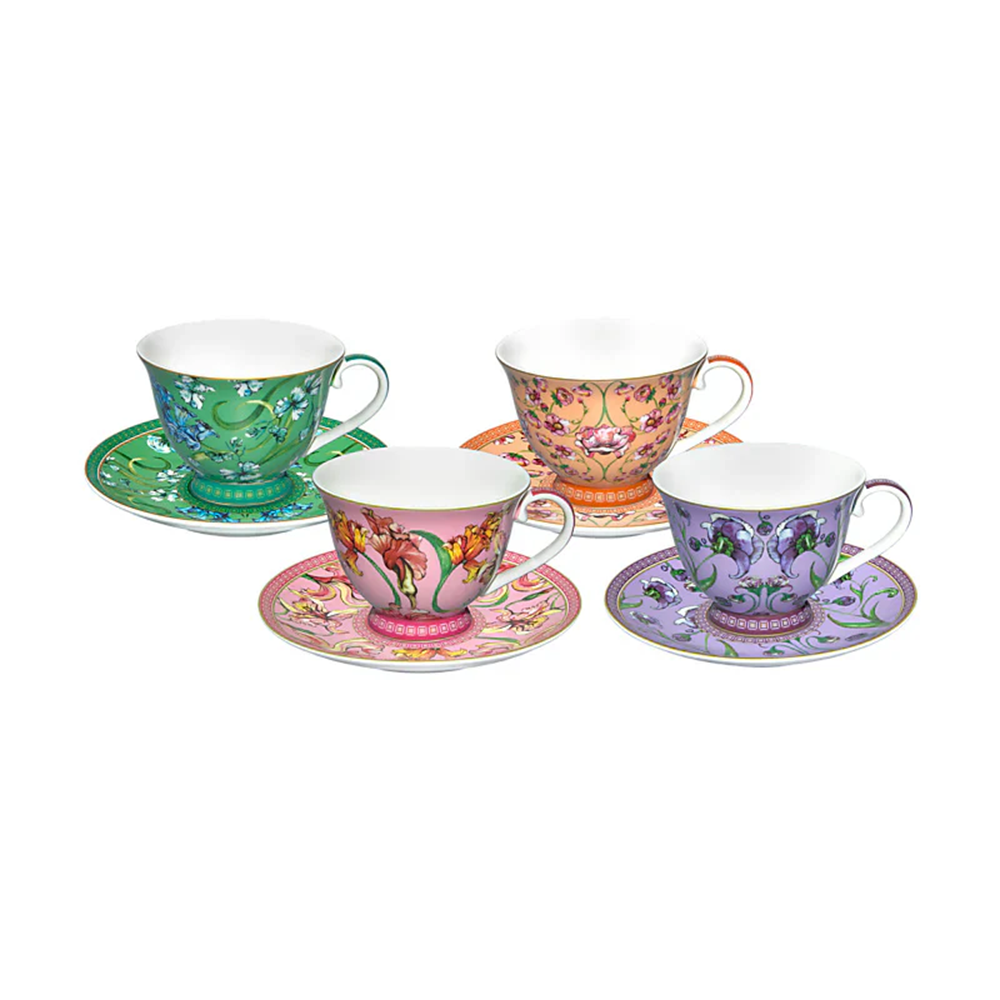 Set of four colorful teacups and saucers on a white background