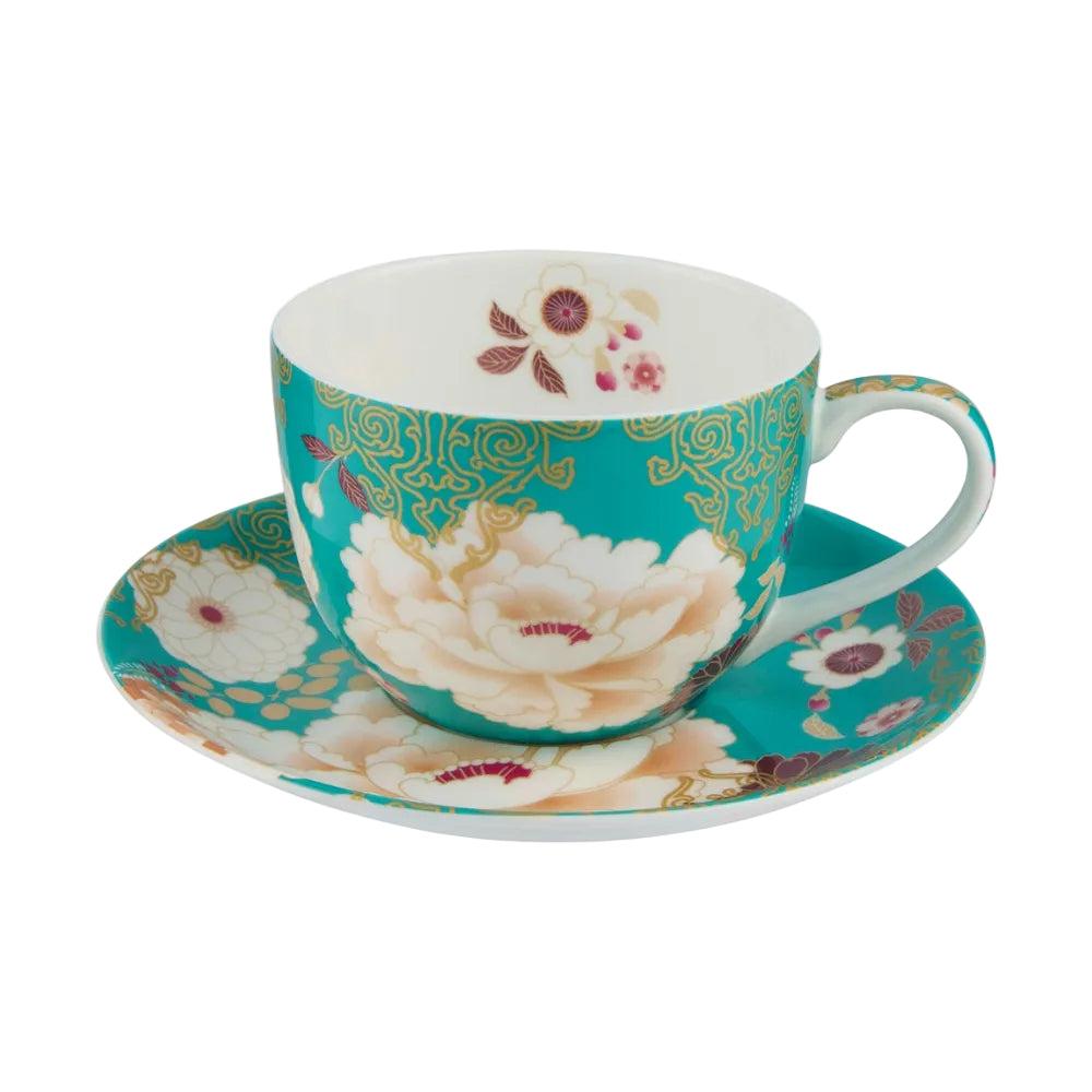 Teacup and saucer with floral design on a white background