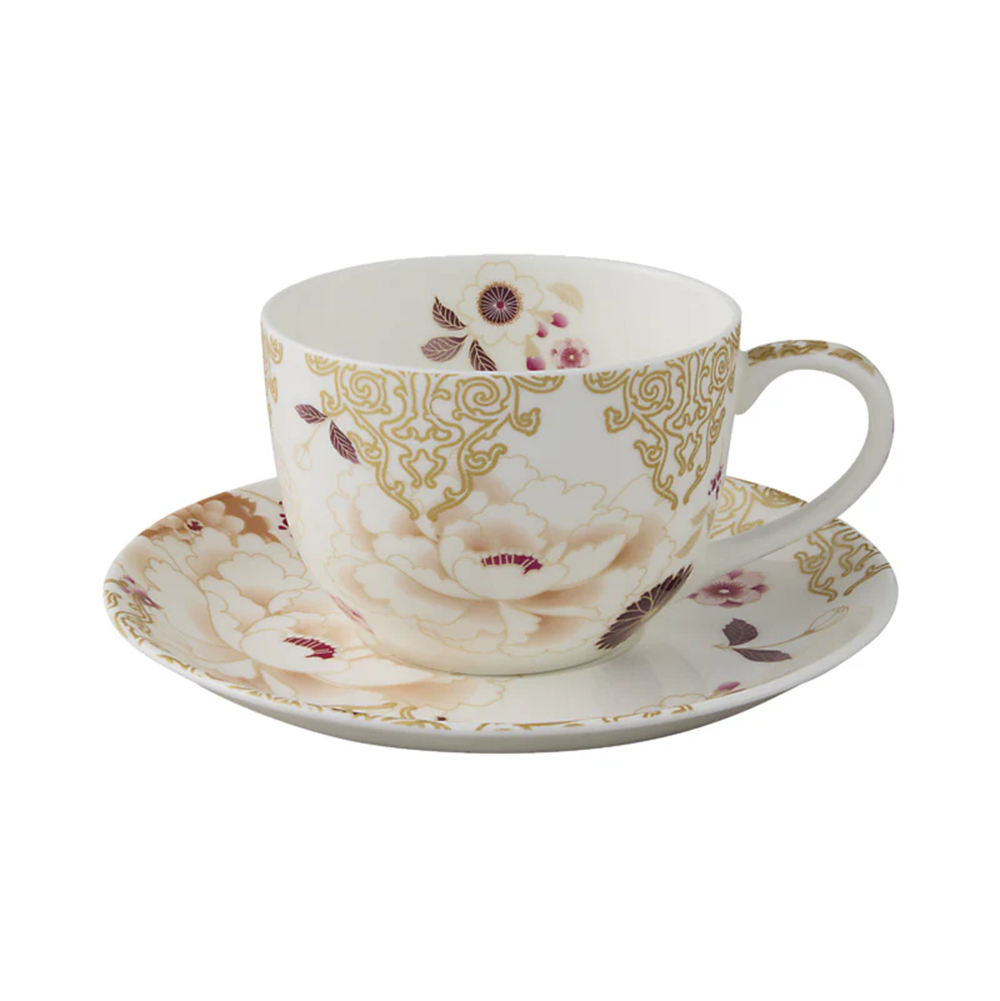 Ceramic cup and saucer with floral design on a white background