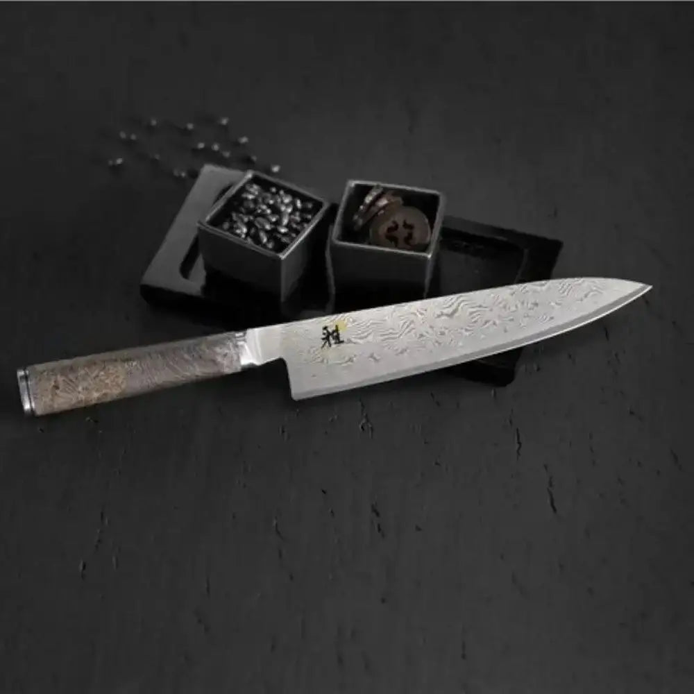 Decorative knife with engraved details on a dark surface