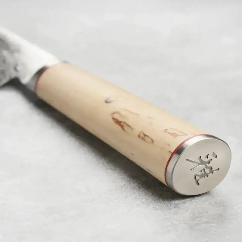 Wooden-handled knife with metal blade on a light gray background