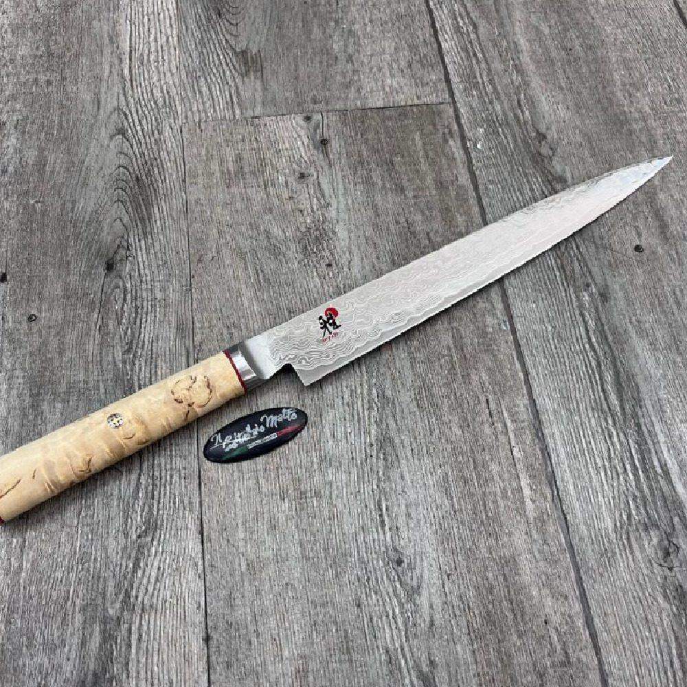 Knife with a wooden handle on a wooden surface