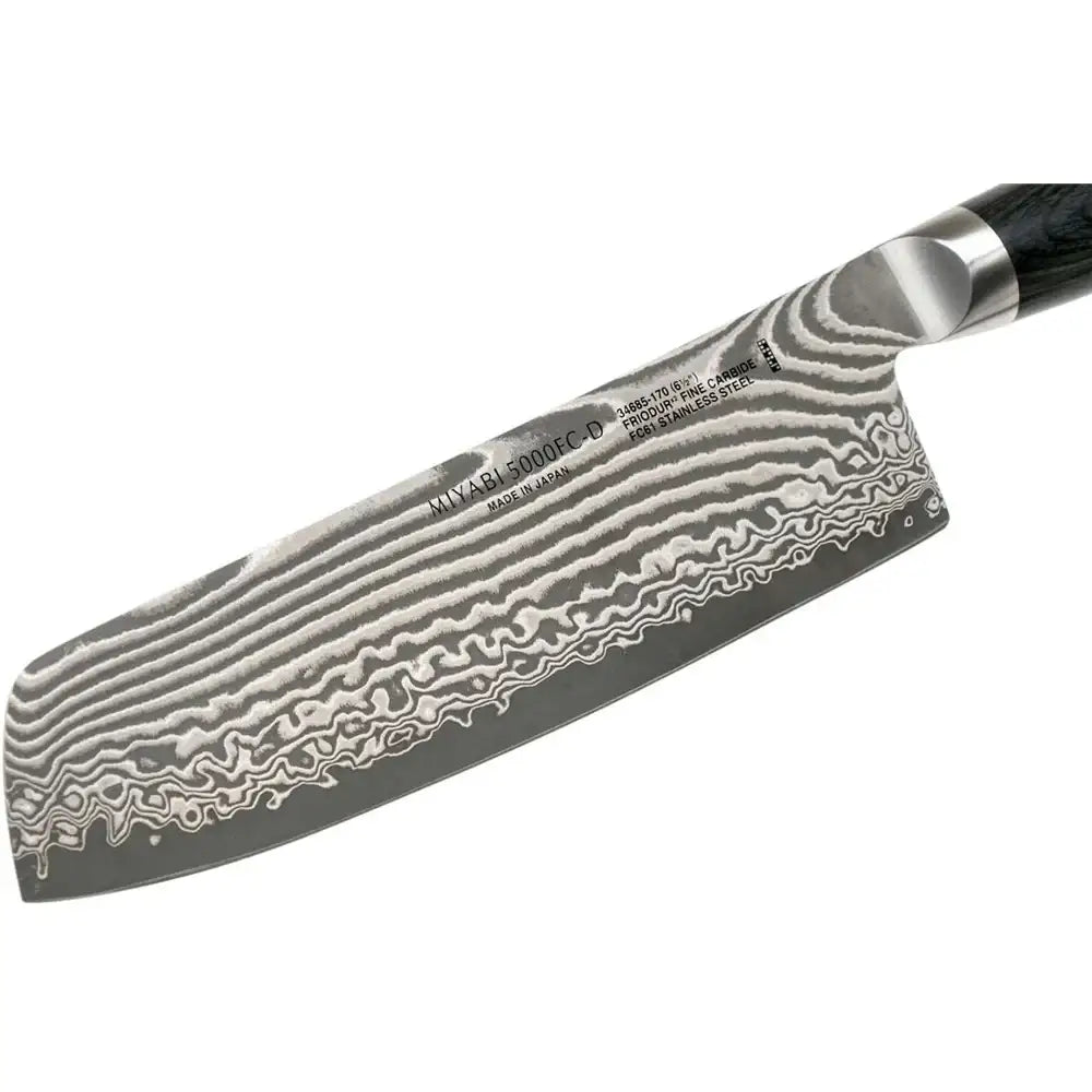 Damascus-patterned knife blade with a black handle on a white background