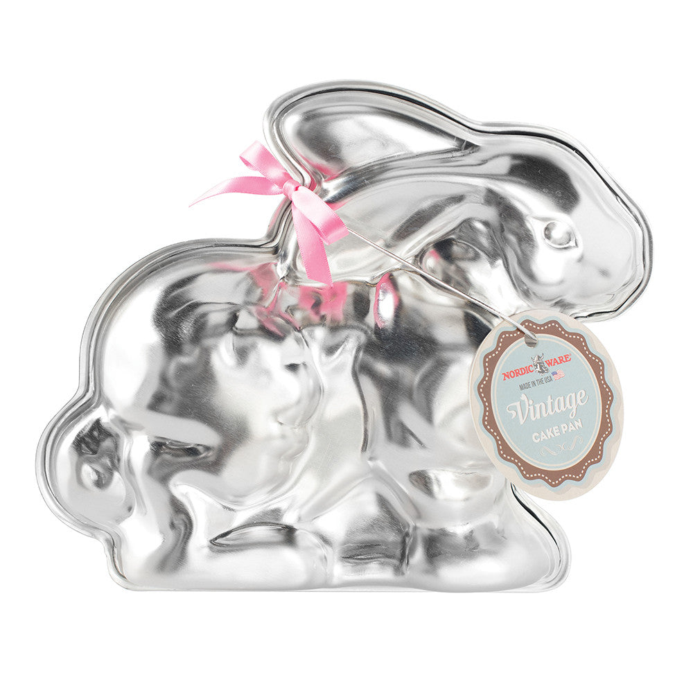 Silver rabbit-shaped candy mold with pink bow and tag on a white background