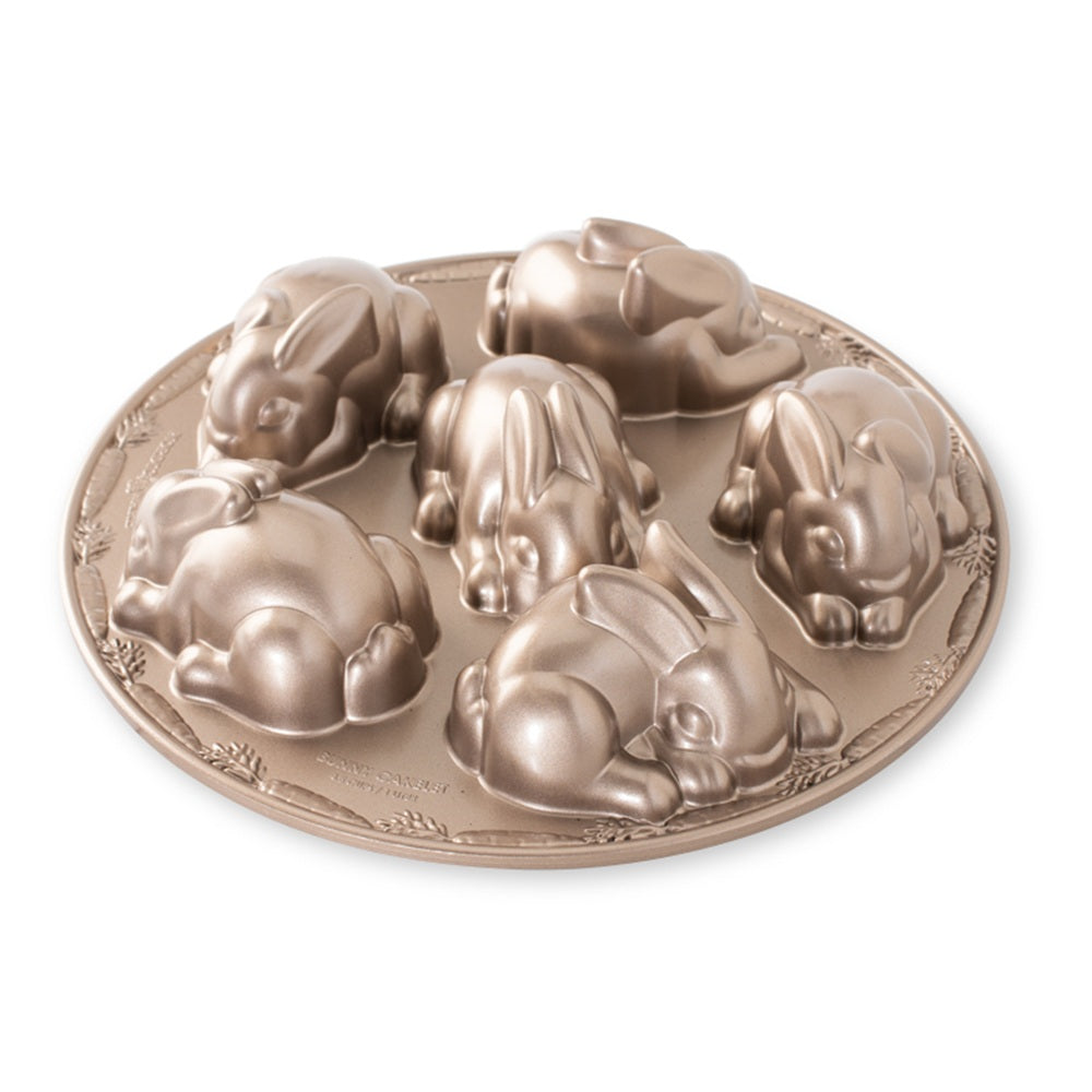 Bronze cake mold with rabbit shapes on a white background
