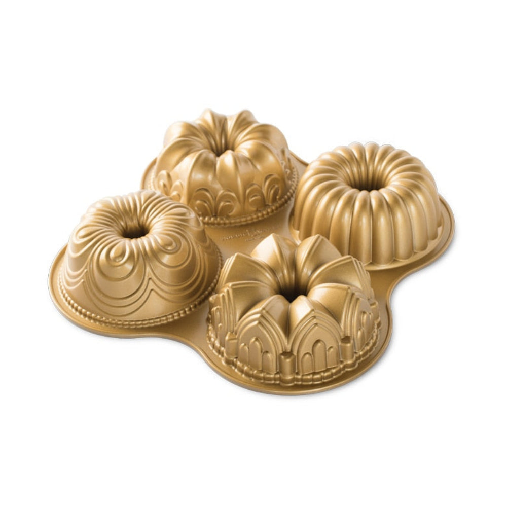 A gold-colored four-bundt pan with decorative embossed patterns, shown on a clean white background.