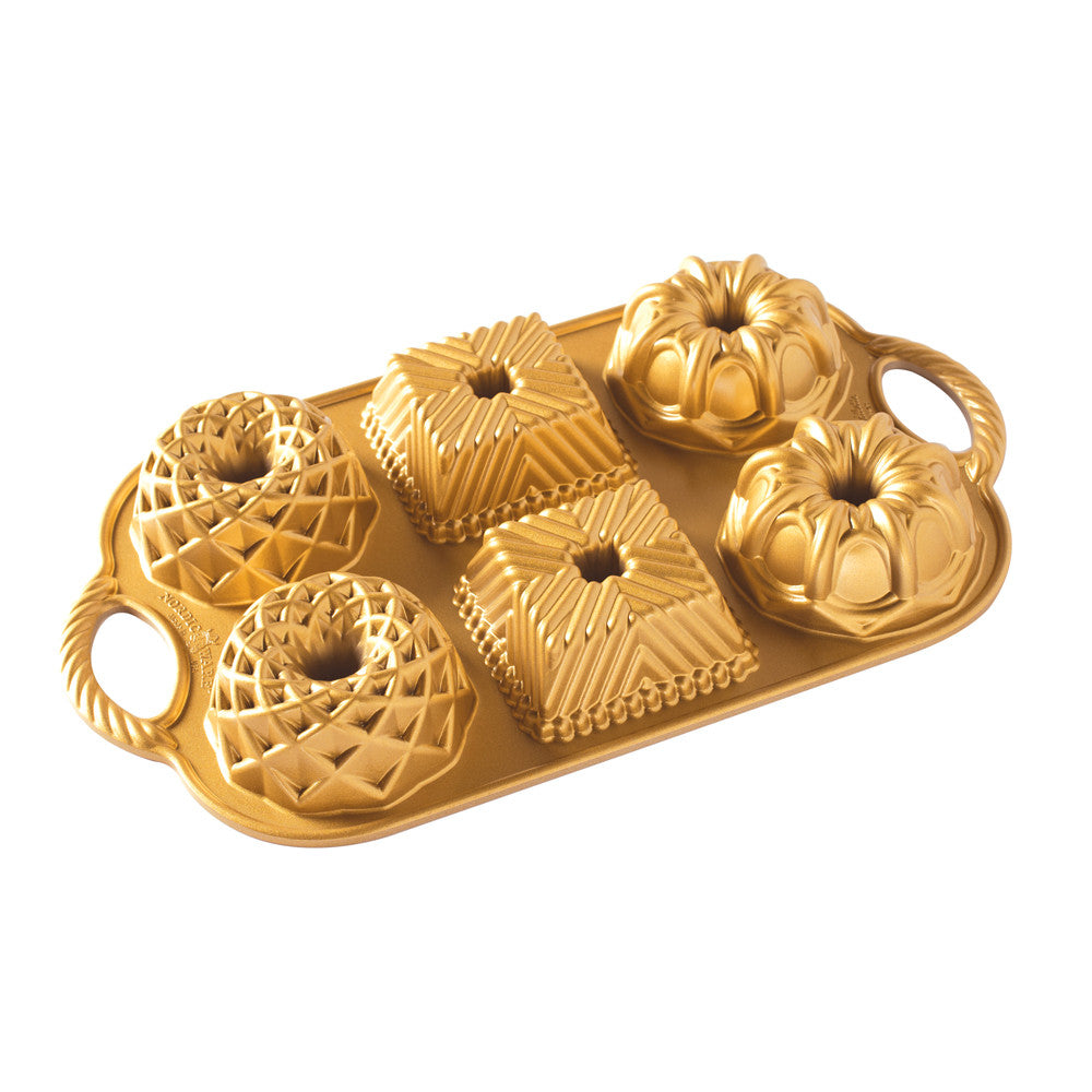 Gold decorative mold with intricate designs on a white background