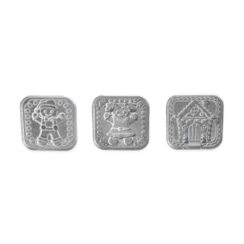 Metallic cookie stamps with gingerbread designs on a white background