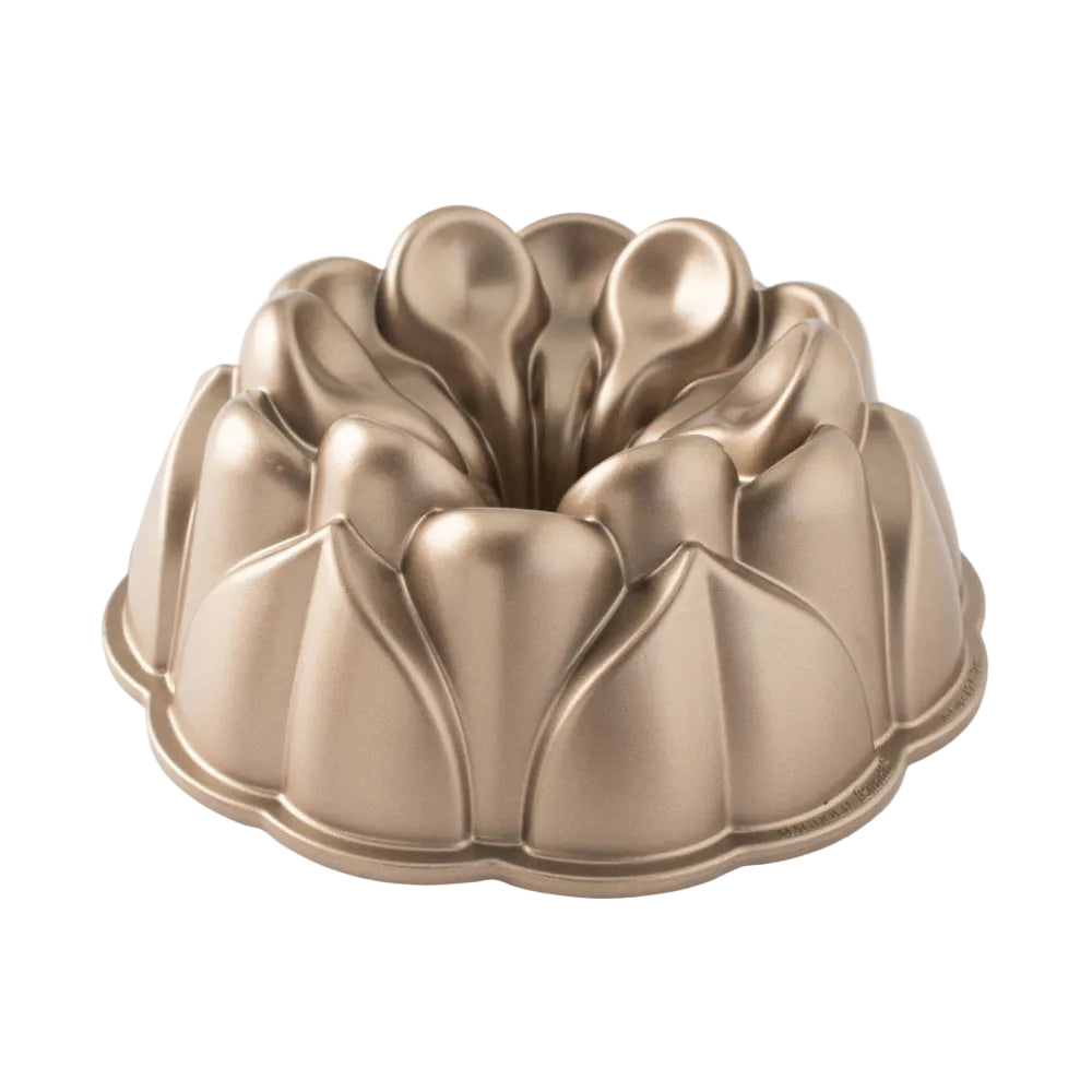 Gold Bundt cake pan on a white background