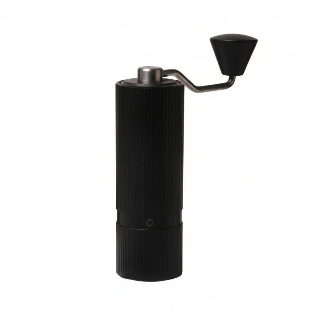 A manual electric coffee grinder with a ribbed black body, a silver metal top button, and a black hand-crank handle, shown on a solid white background.