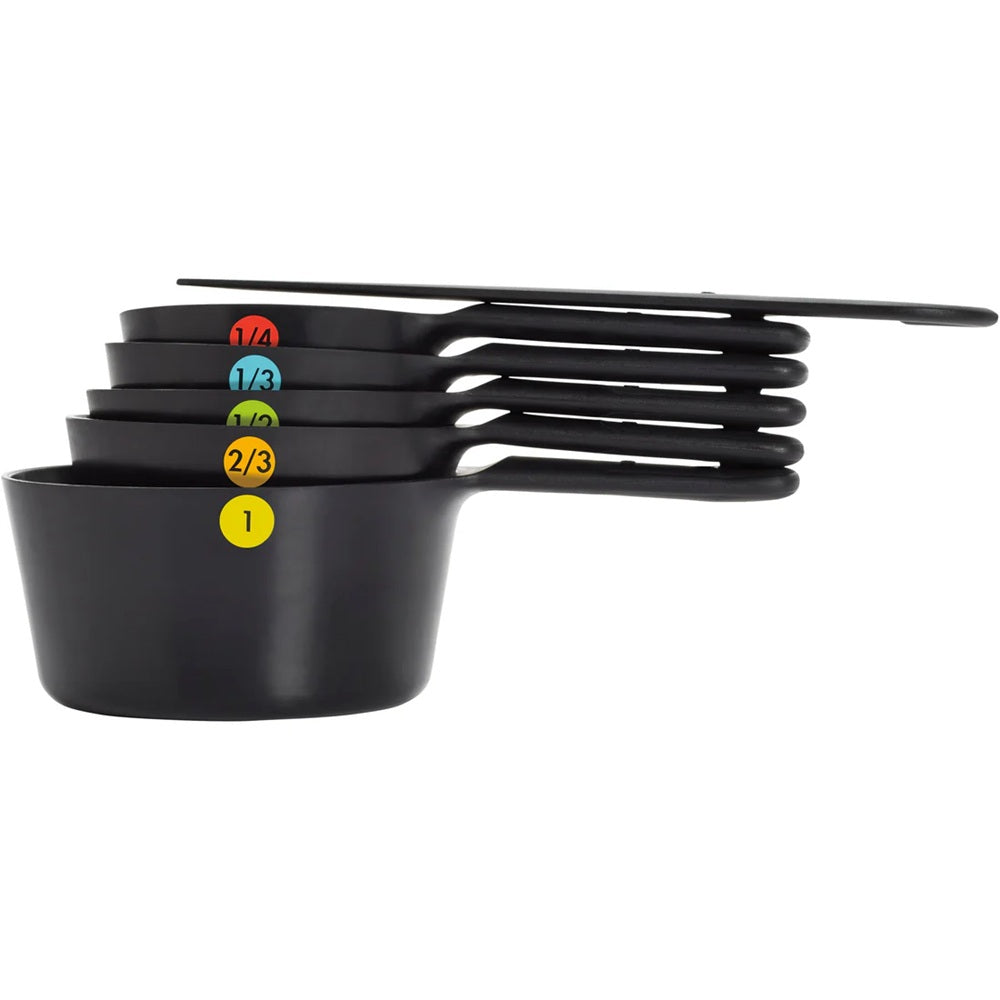 Set of black measuring cups with color-coded markings on a white background