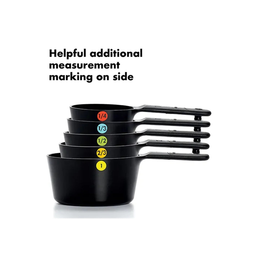Set of black measuring cups with color-coded markings on a white background