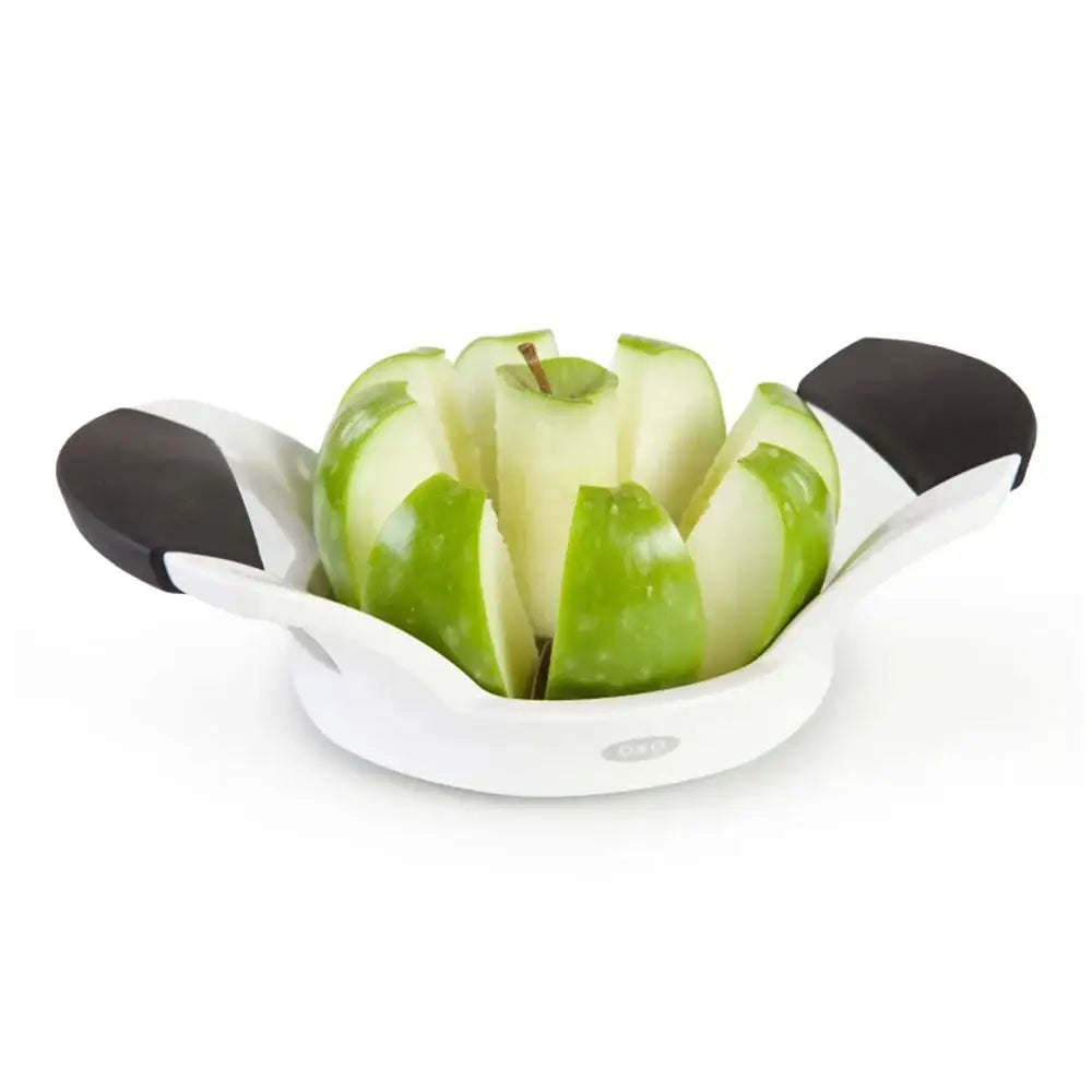 Apple corer with green apples on a white background