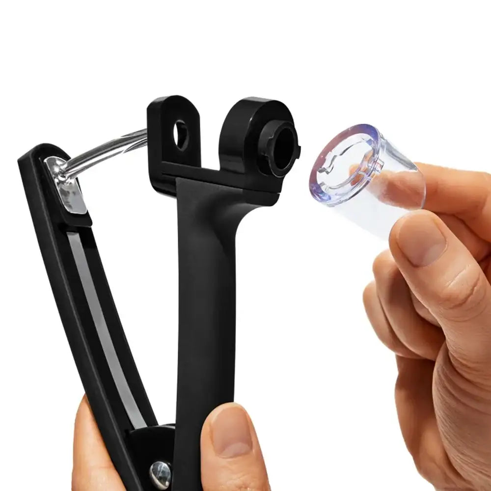 Black metal tool with a clear plastic component held by a hand on a white background