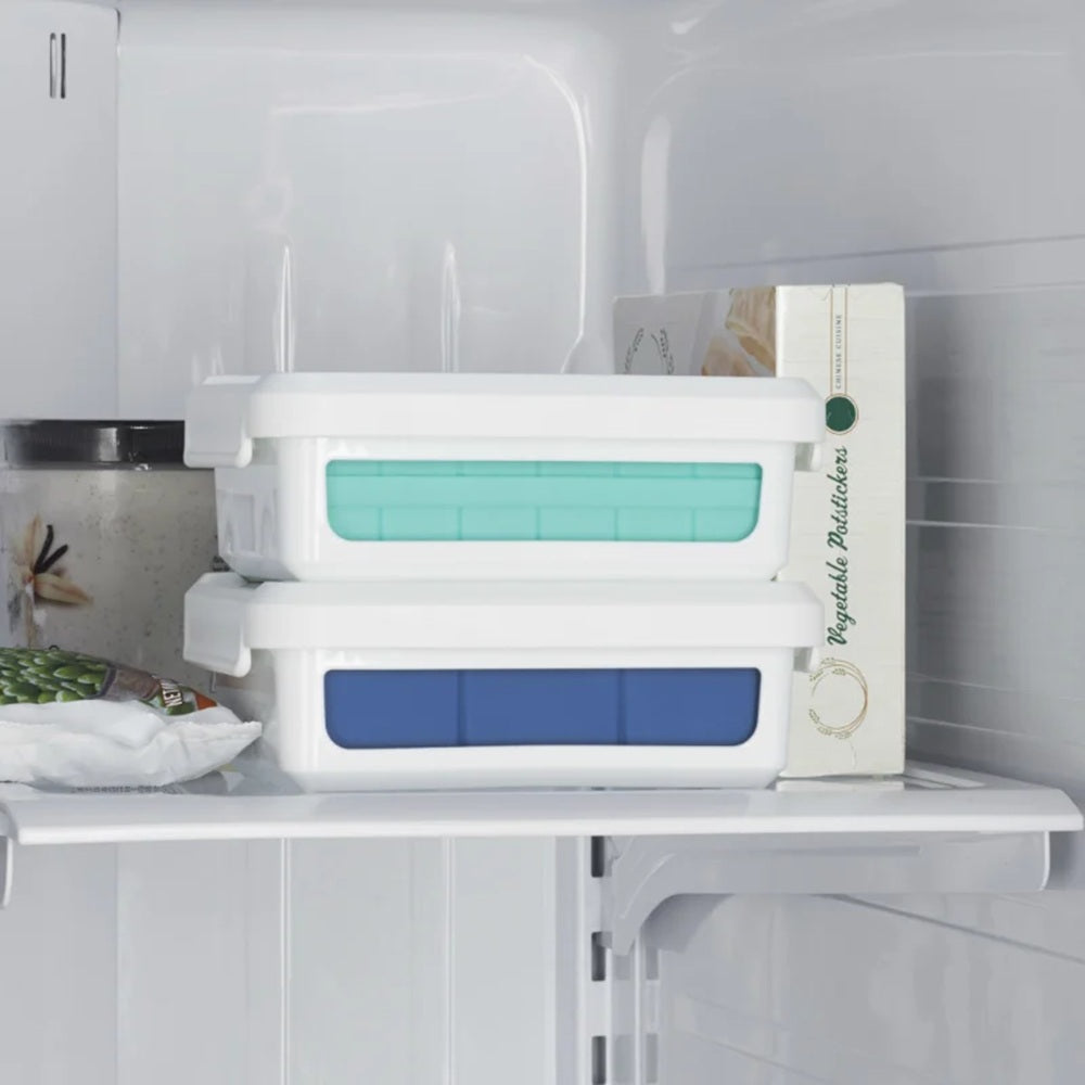Stackable storage containers with blue and green lids inside a refrigerator.