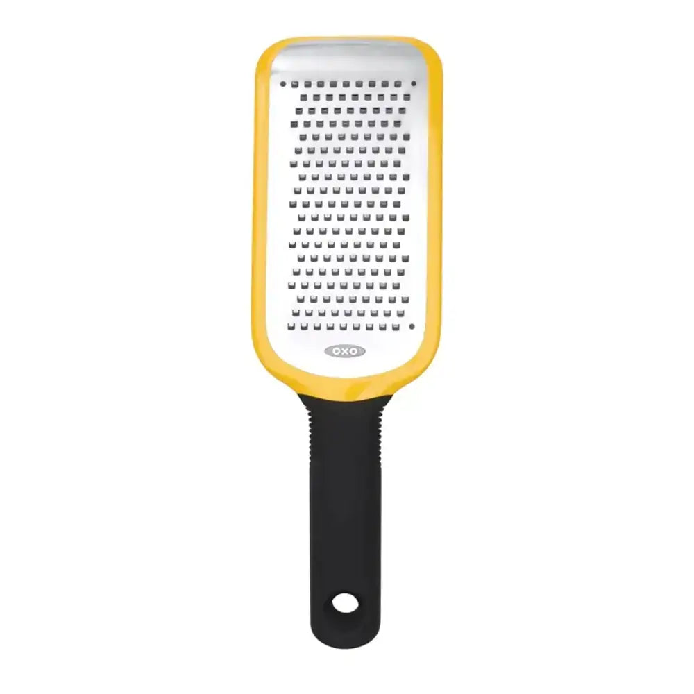 Yellow and black OXO grater on a white background