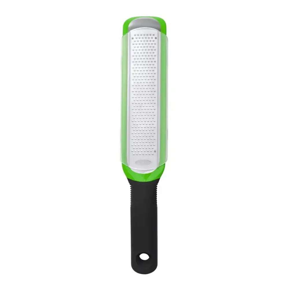 Grater with green handle and white surface on a white background