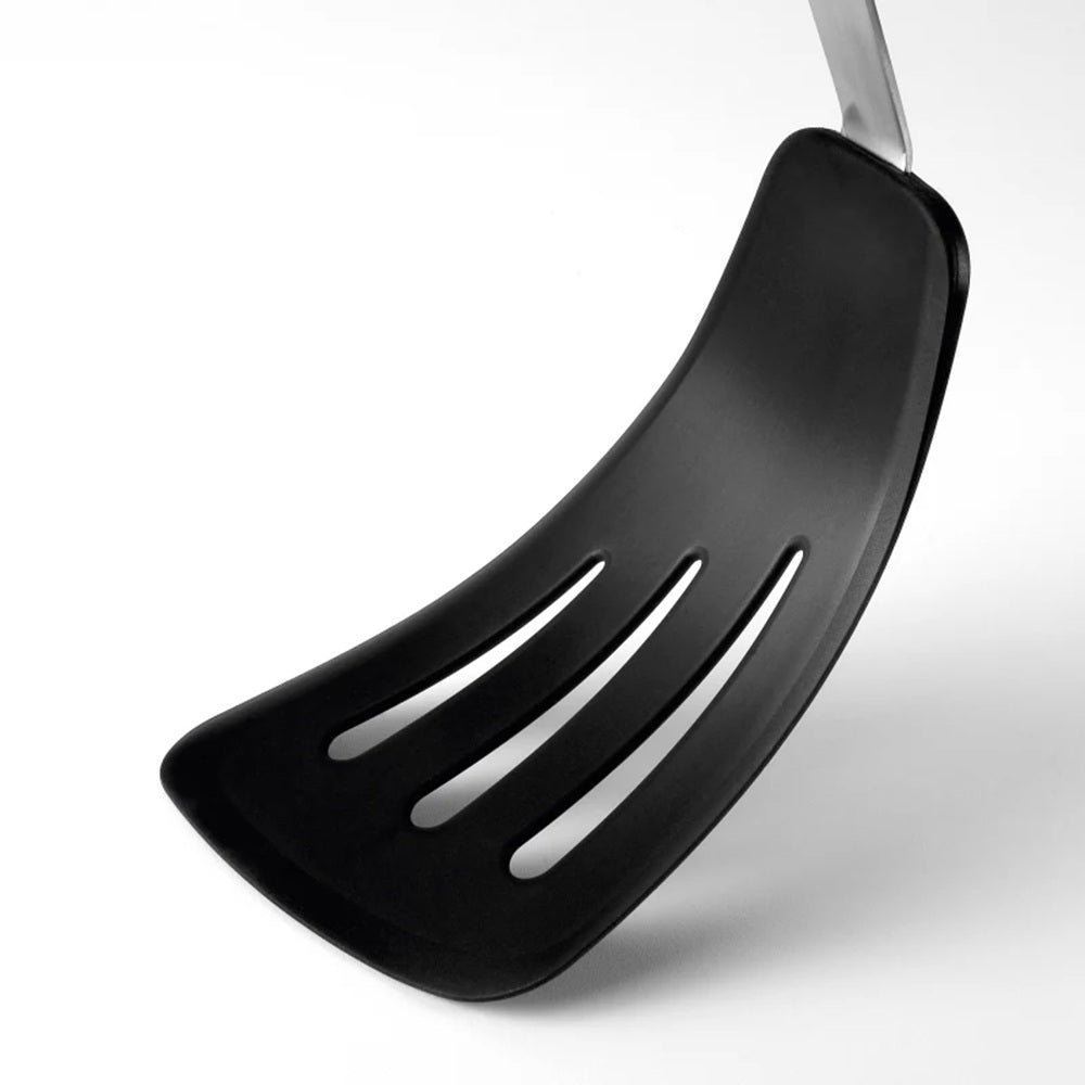 Black slotted spatula on a white background