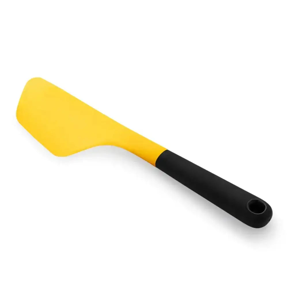Yellow spatula with black handle on a white background