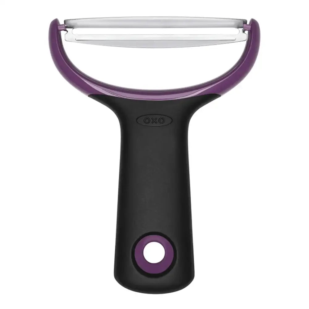 Oxo vegetable peeler with purple handle and blade on a white background