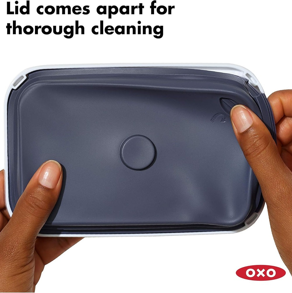 OXO food container with lid being held open, showing text 'Lid comes apart for thorough cleaning'.