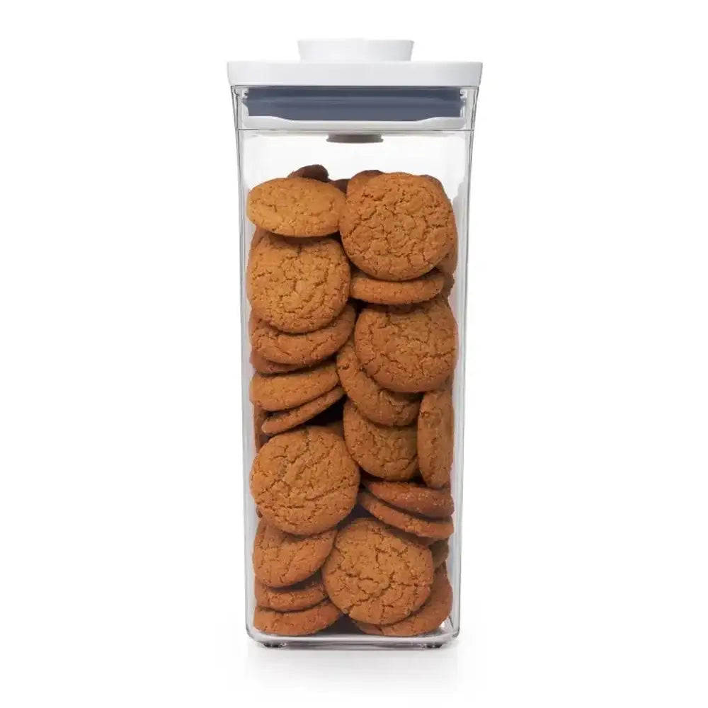Clear container filled with cookies on a white background