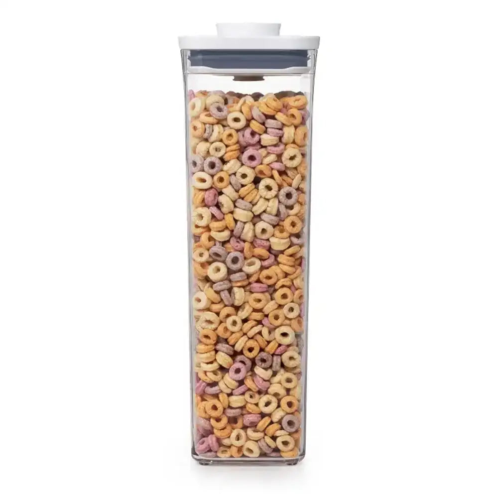 Clear container filled with colorful cereal loops on a white background