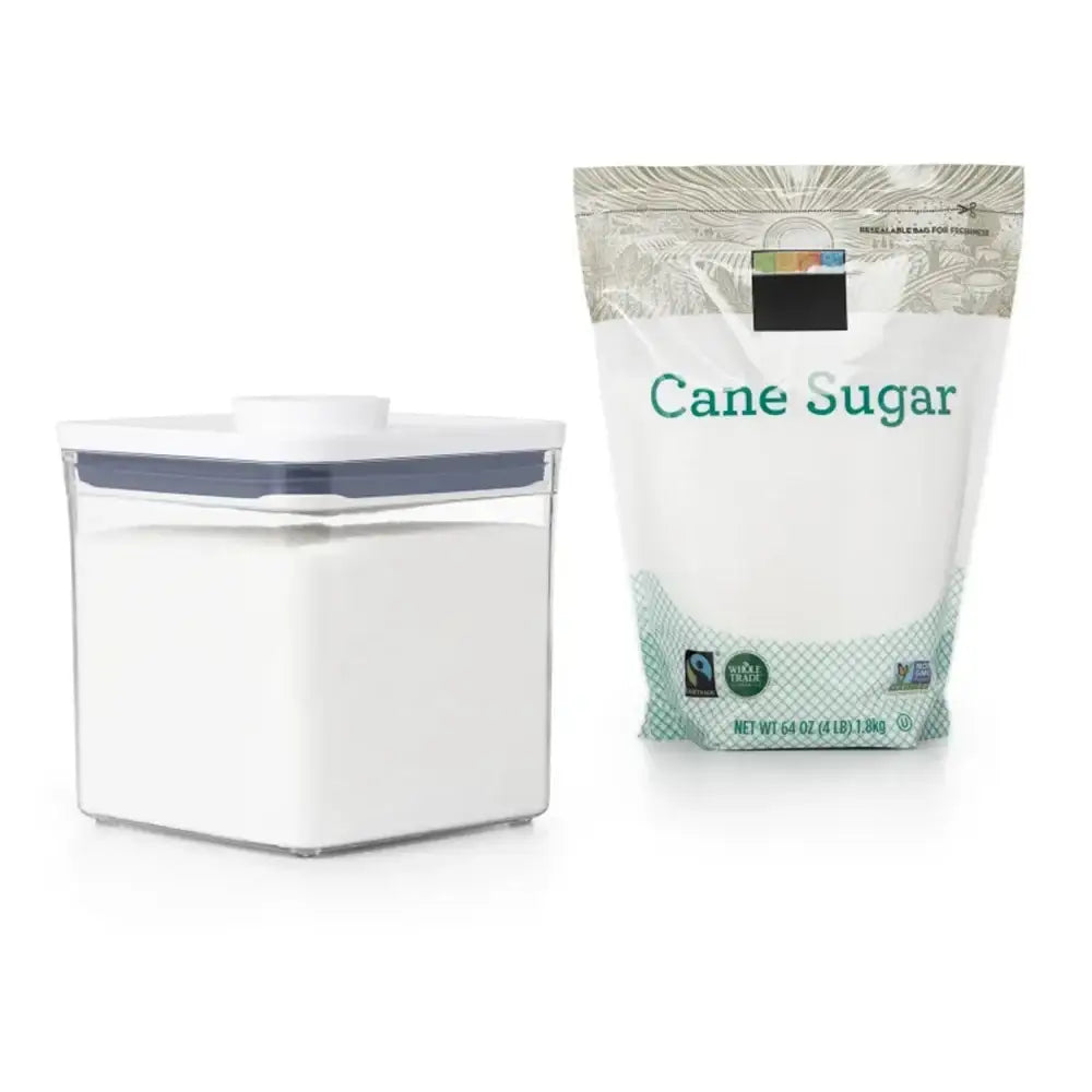 White container and bag labeled 'Cane Sugar' on a white background