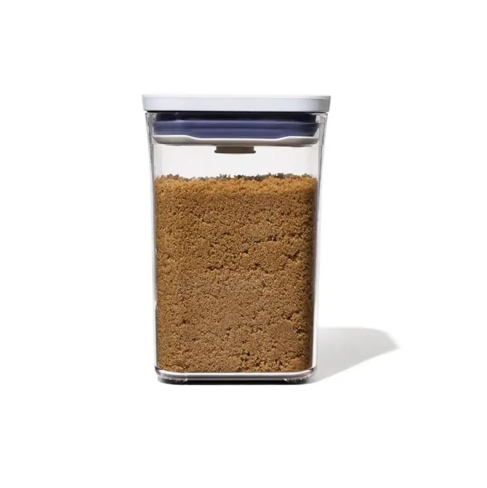 Clear container with brown substance on a white background